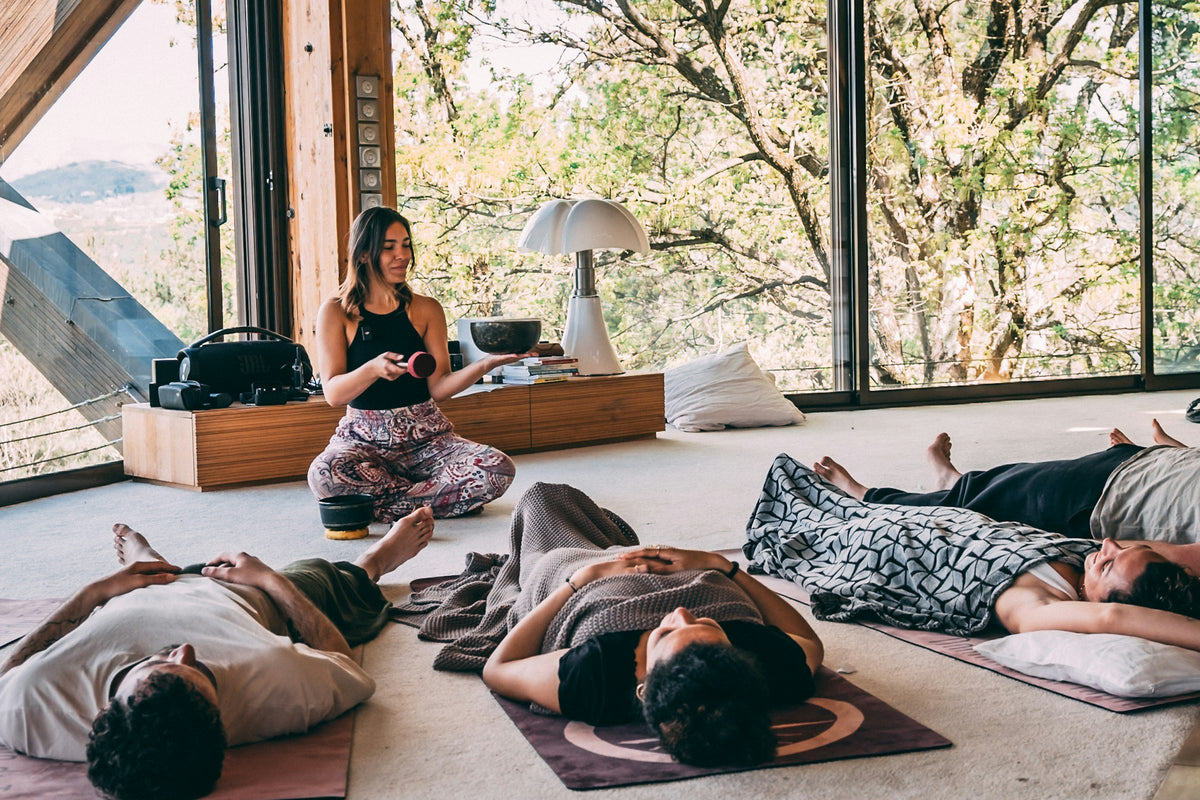 Group meditation in a glass-walled forest retreat