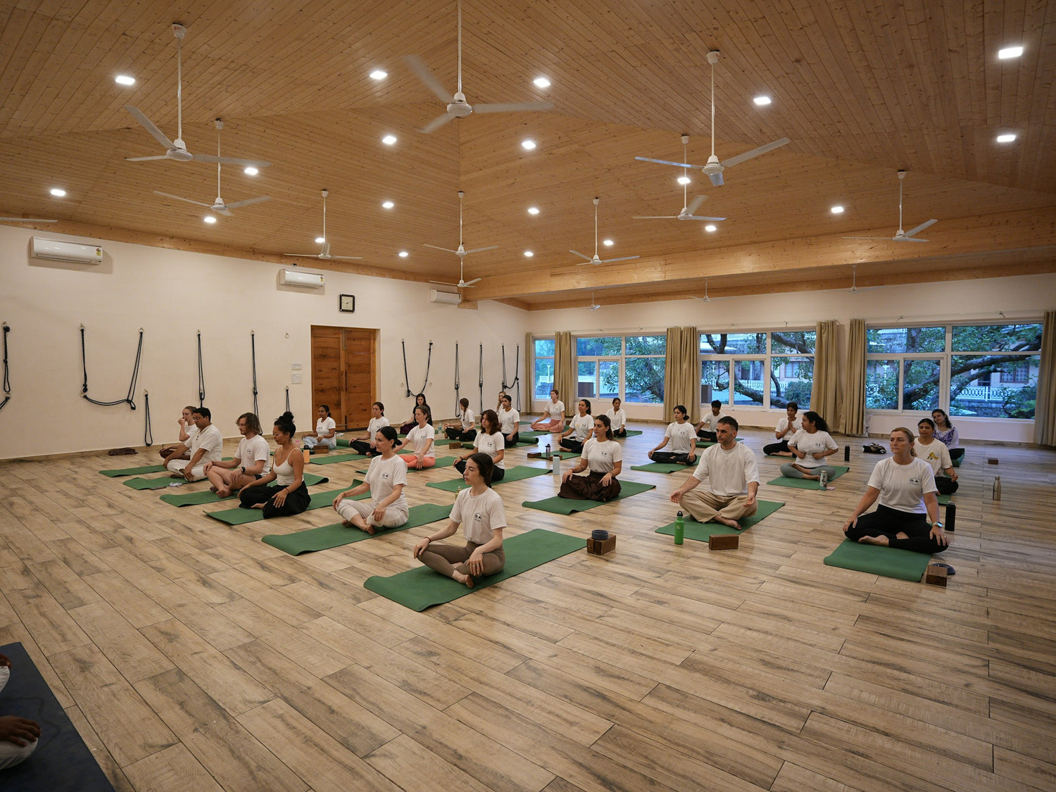 Group practicing meditation and breathwork in a yoga studio